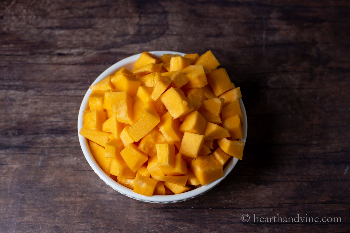 Chunks of bite size fantasy pumpkin in a white bowl.