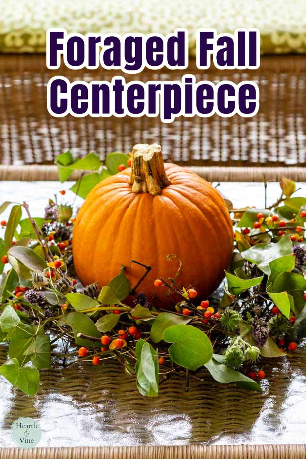 Fall foraged arrangement wreath with a small pumpkin in the center.