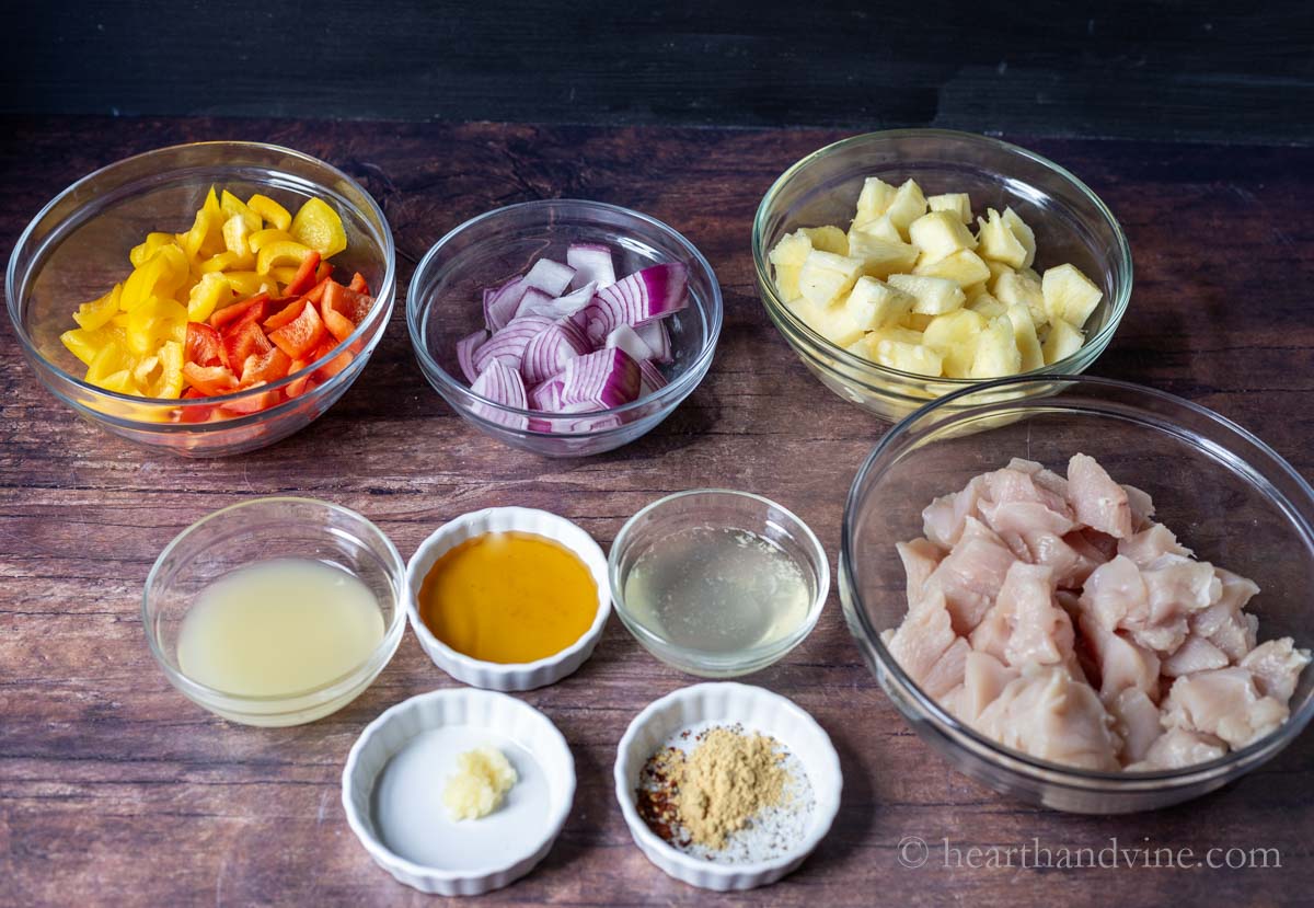 Ingredients including chicken breast, peppers, onions, pineapple, lemon juice, garlic, spices, honey and pineapple juice.