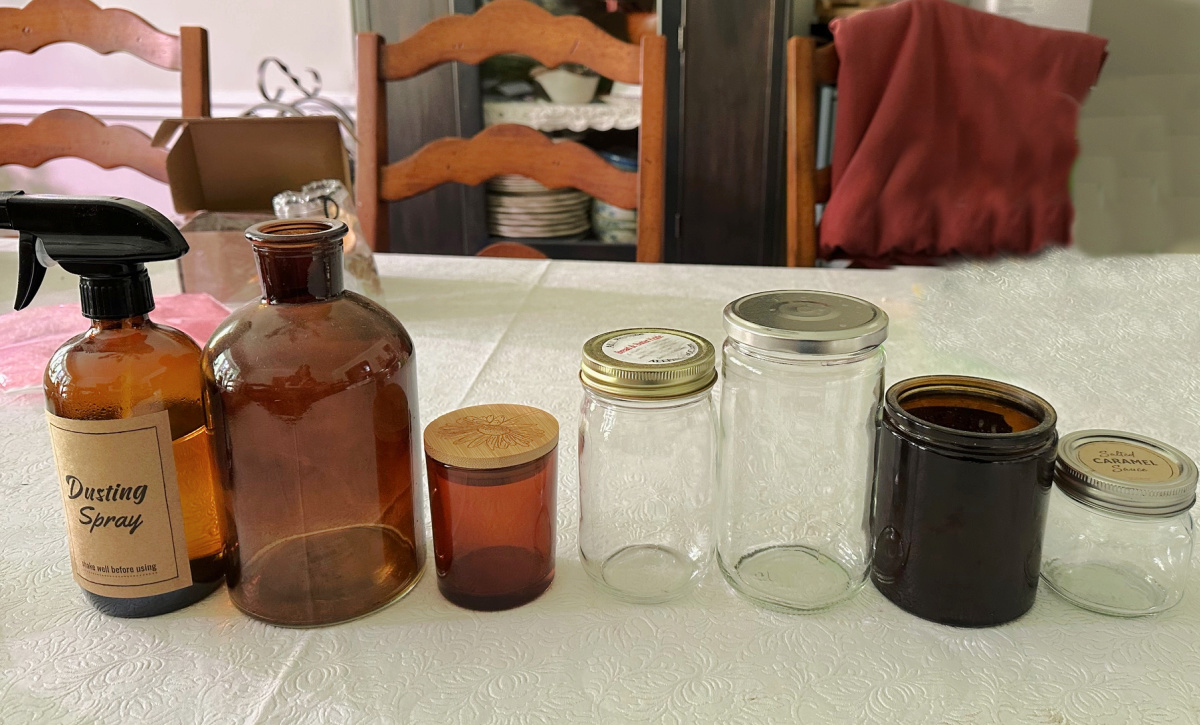 Amber and clear bottles on a table.
