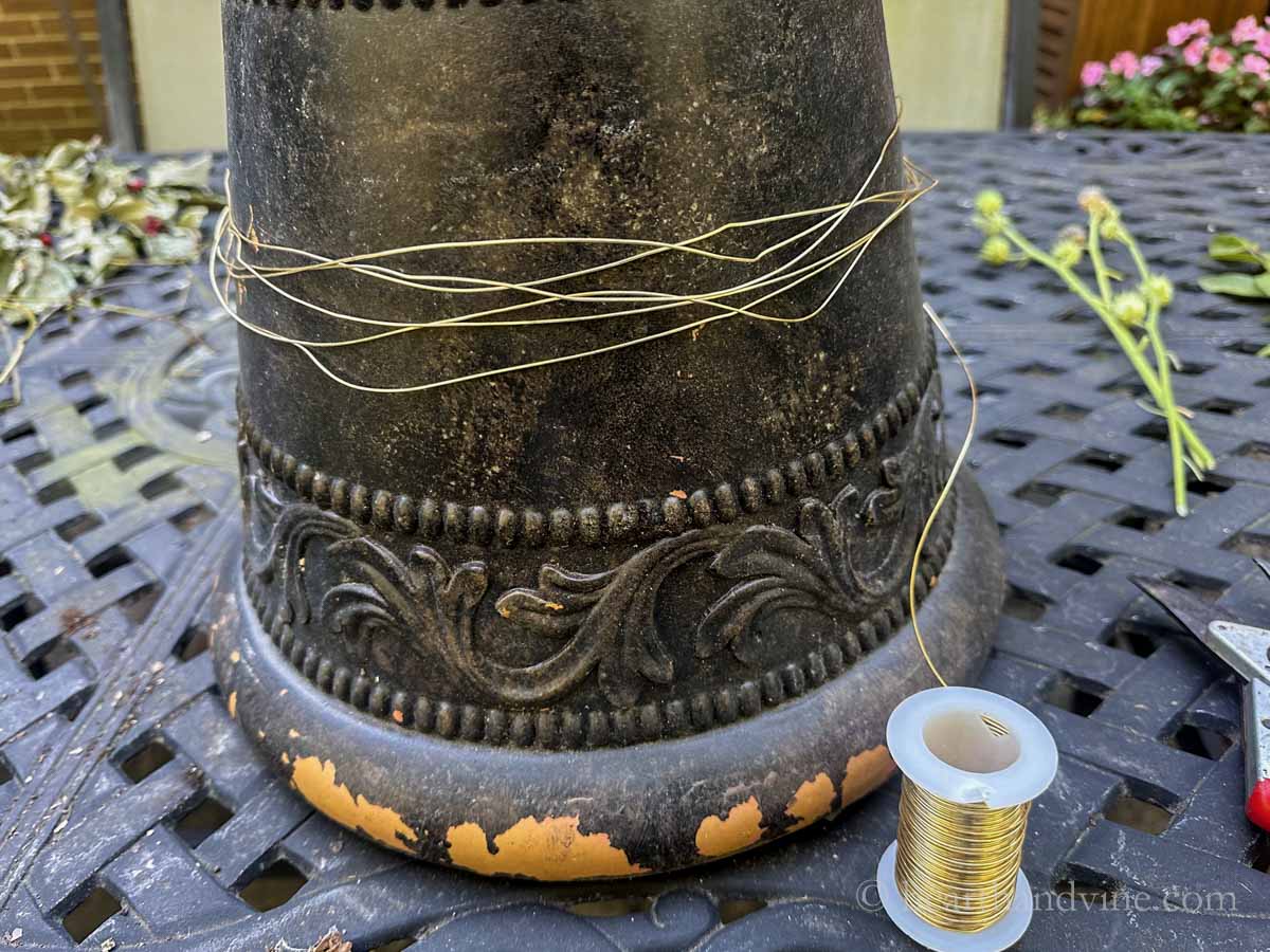 Gold wire wrapped around an old flower pot.