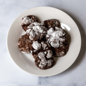 Chocolate crinkle cookies on a plate.