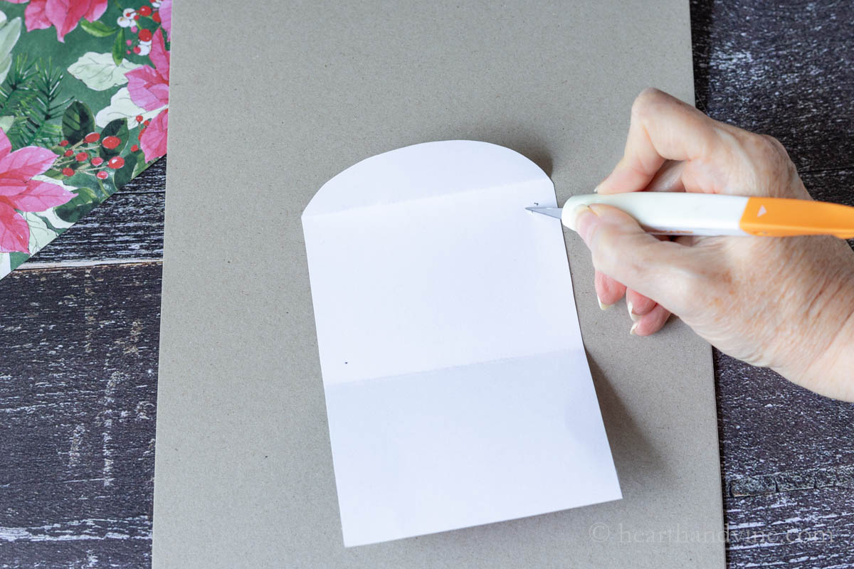 Cutting a slit into the gift card holder with an exacto knife just inside the pencil dots.