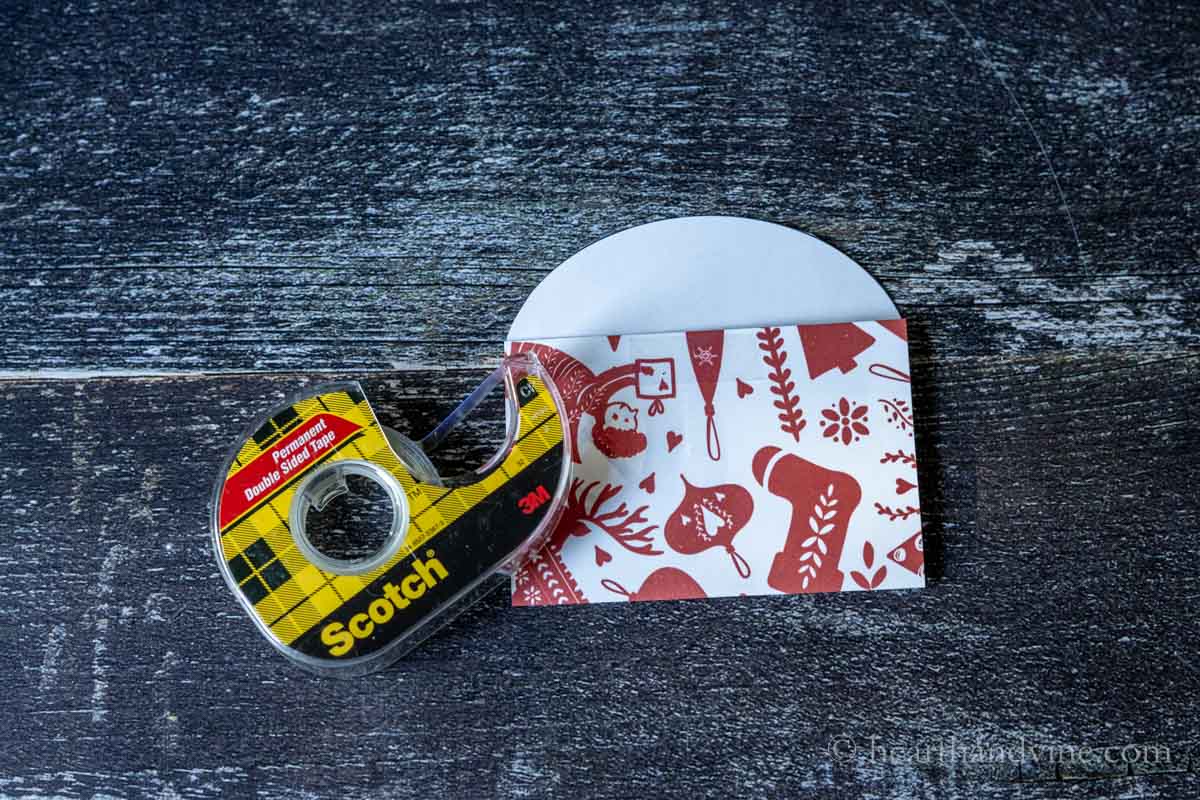 Double sided tape on the top edge of the outside of the gift card holder.