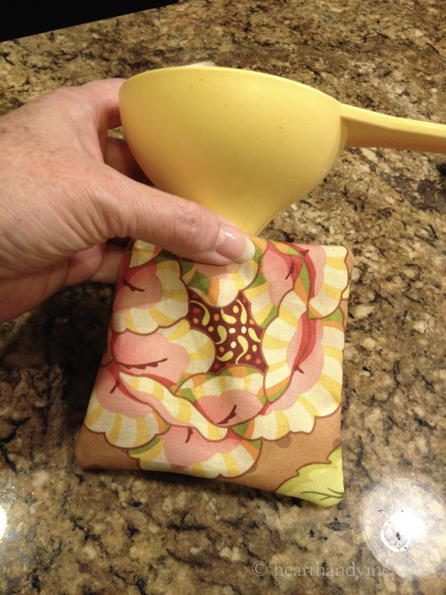 A plastic funnel in a mug mat open edge to filled with spices.