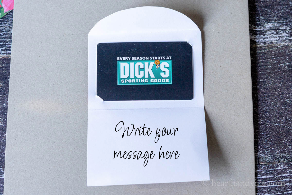 A view showing a Dick's gift card inserted into the gift card holder.