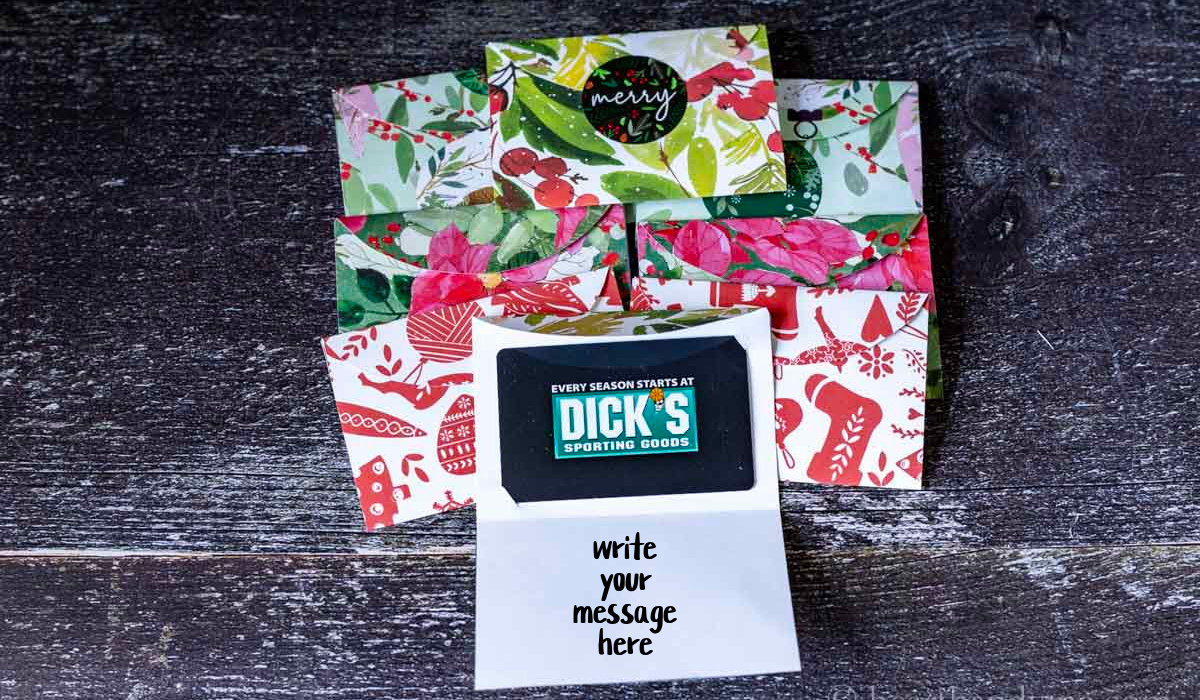 A group of gift card holders and one a the bottom center showing the holder open with the gift card and a space for the message.