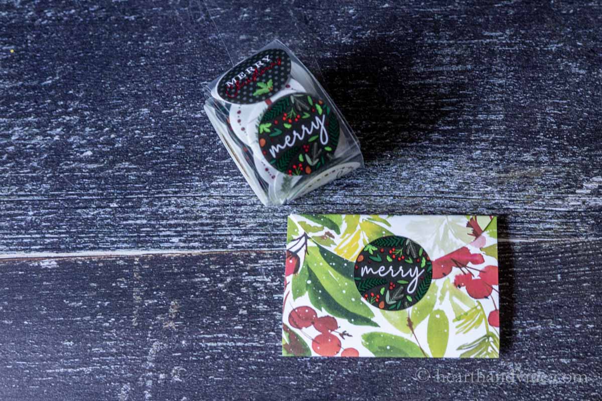 A large round sticker that says "Merry" used to close the gift card holder.