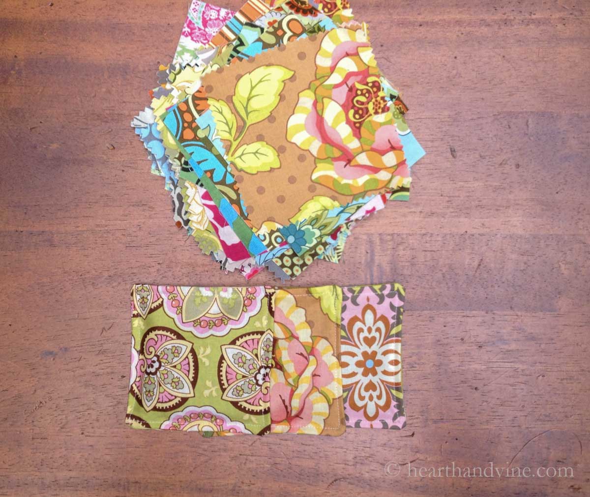 A stack of colorful printed cotton fabric squares over a trio of spiced mug mats.