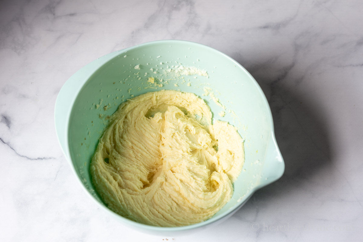 Wet ingredients in a bowl including butter, sugar, eggs and vanilla.