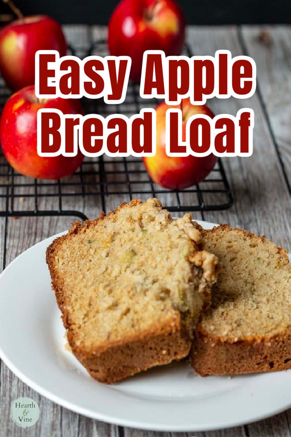 Two slice of apple bread near mini red apples.