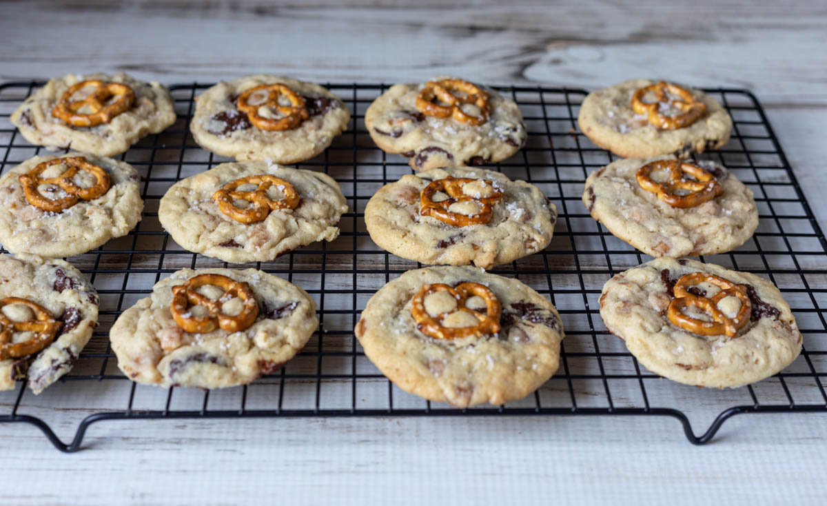Caramel pretzel chocolate chip cookie on a wire cooking rack.