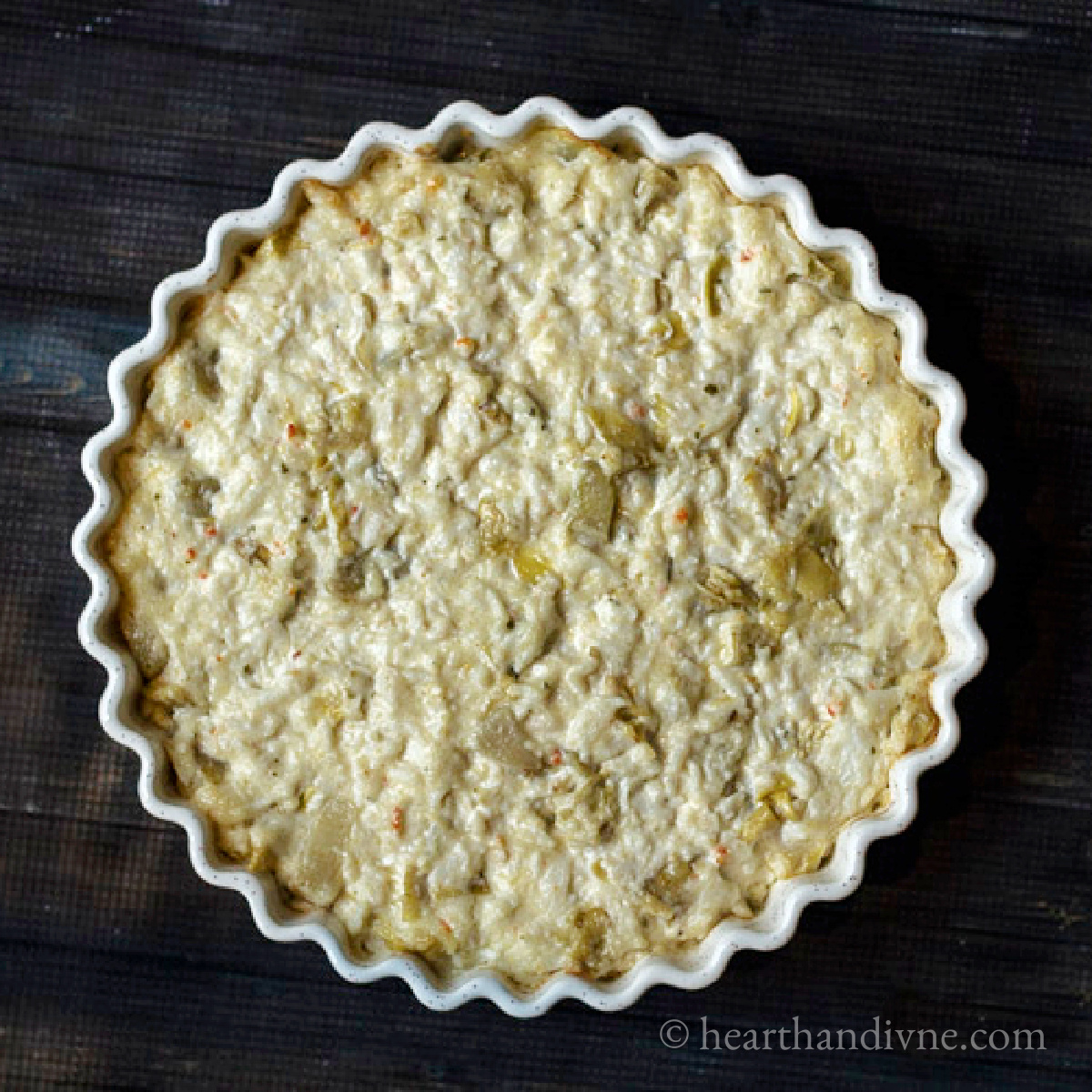 Crab and artichoke dip in a deep dish ceramic pan.