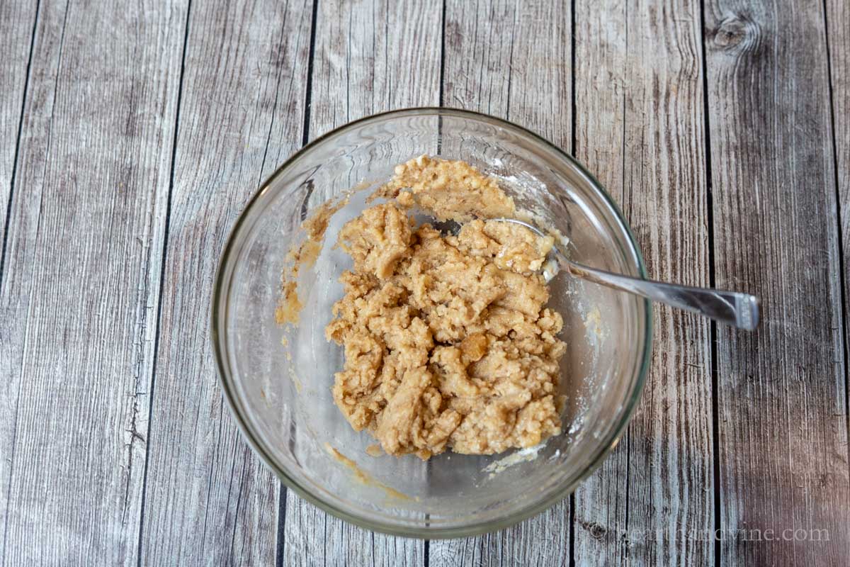Bowl of crumble topping and a spoon.