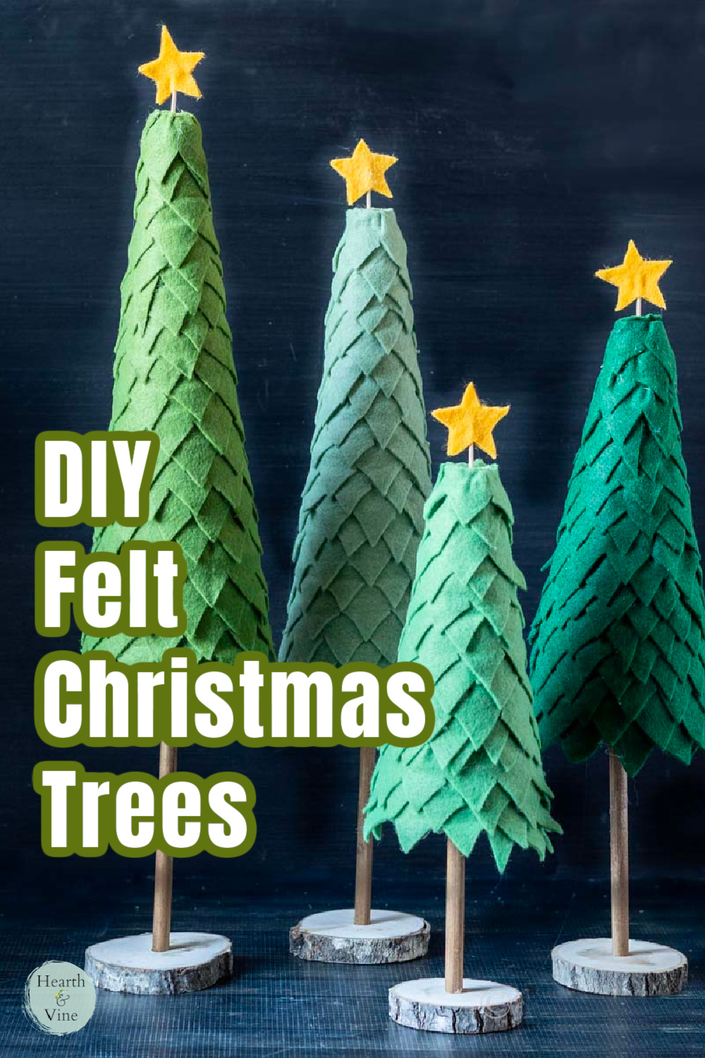 Four felt tabletop Christmas trees in shades of green.