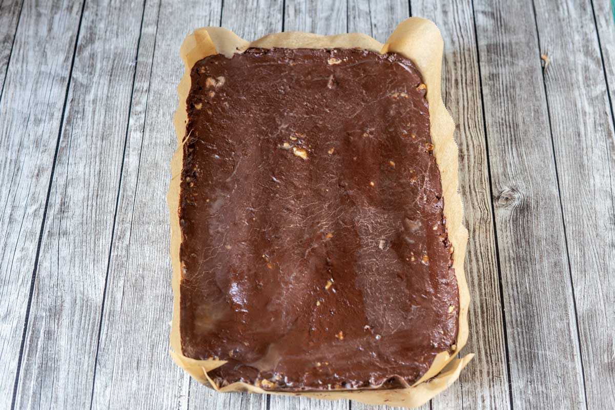 A slab of fudge from the refrigerator on parchment paper.