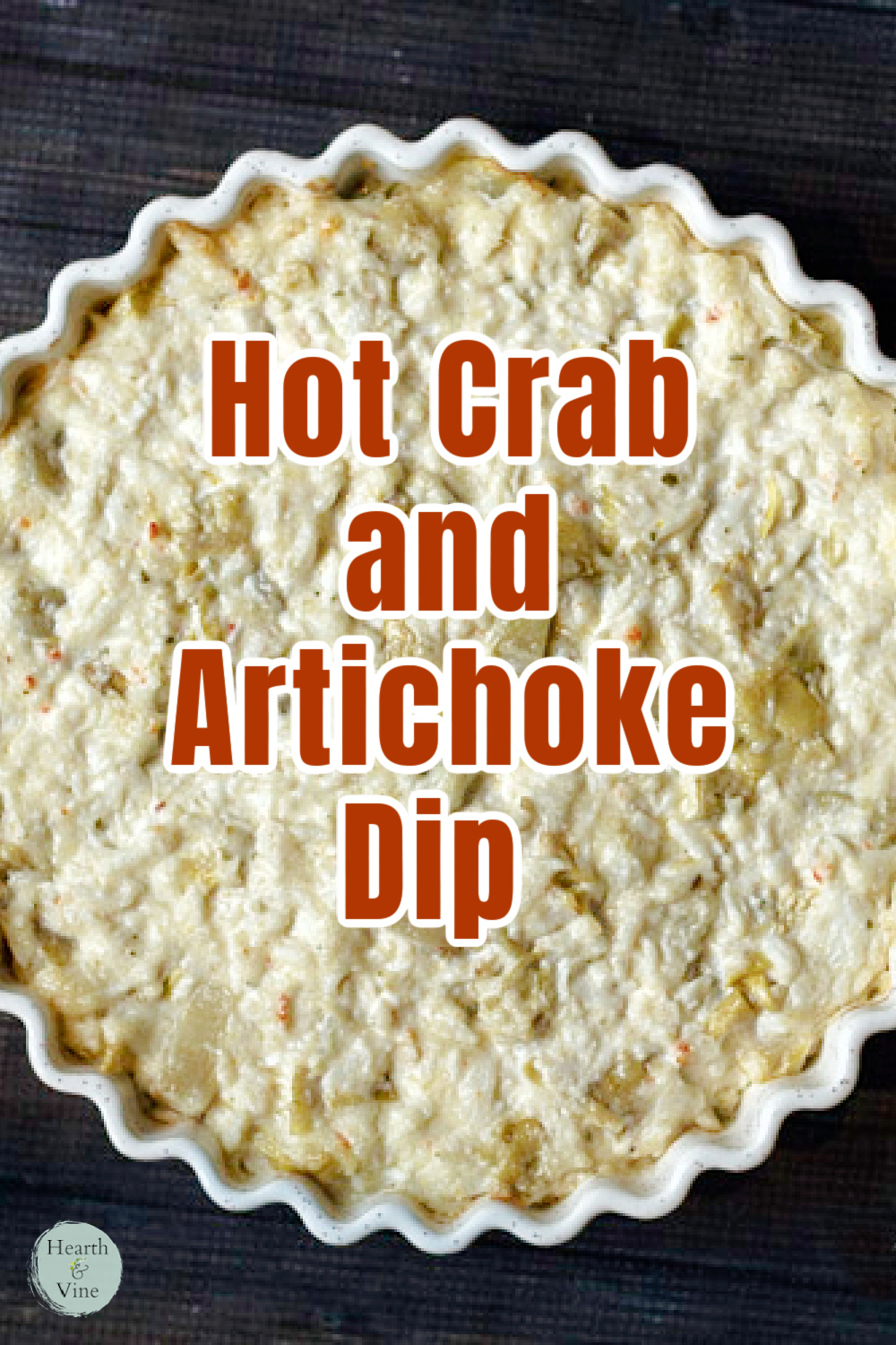 Close up of a crab and artichoke dip in a flute deep dish pan.