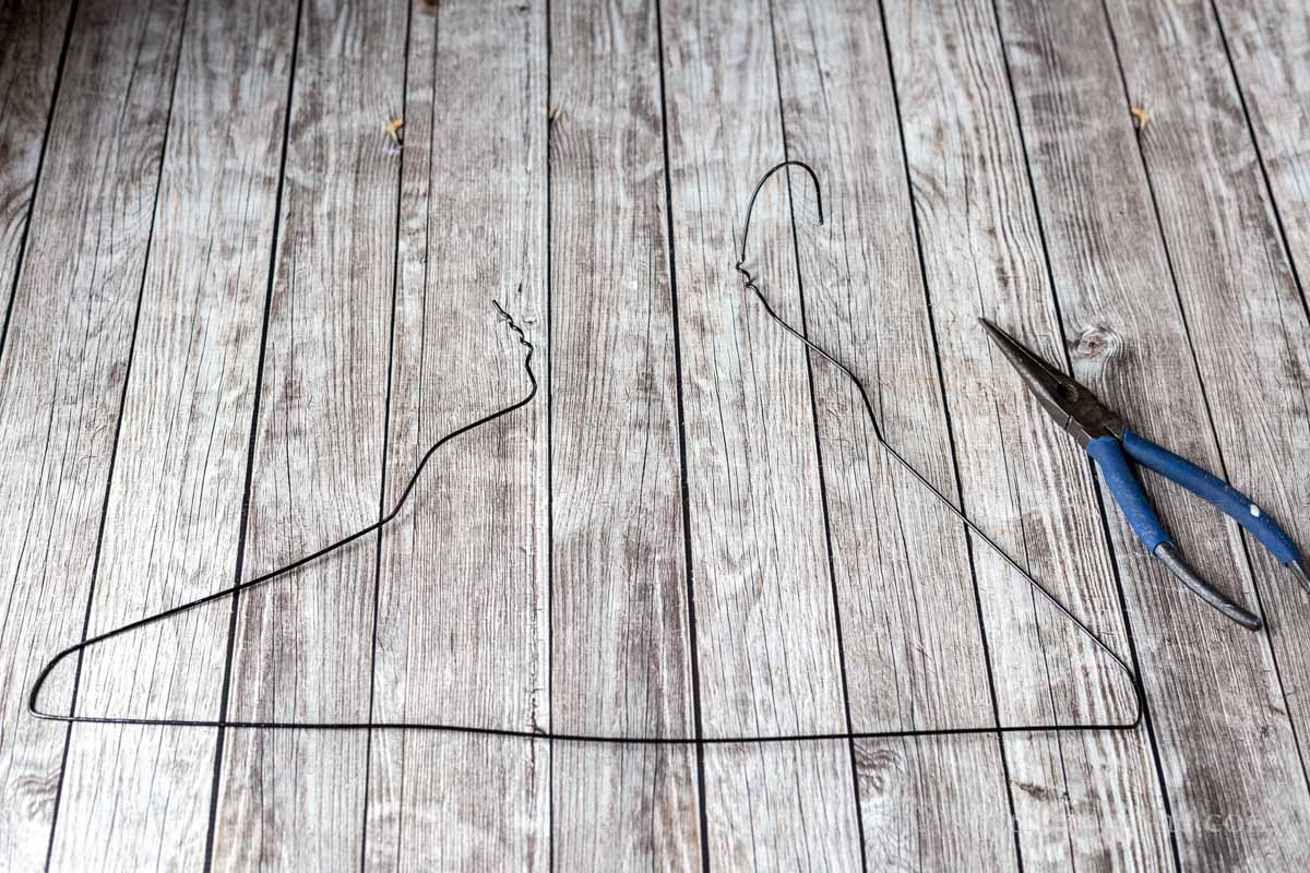 A wire coat hanger opened from the neck and pliers.