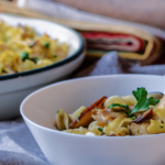 Bowl of leftover turkey casserole with noodles, mushrooms and peas.
