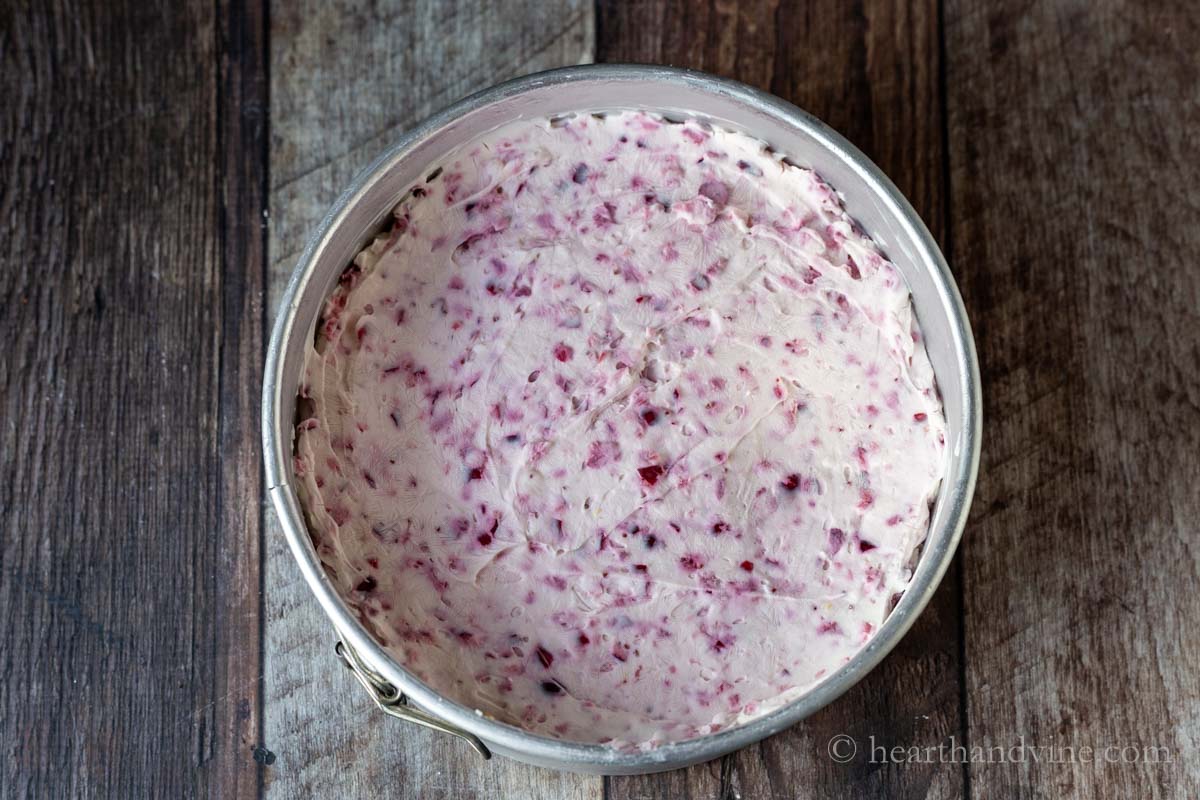Cranberry cheesecake mixture poured into the springform pan.