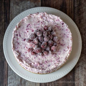 Cranberry cheesecake with sugared cranberries on top.