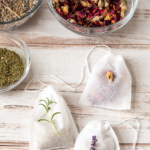 Tea bags with herbs and bowls with dried flowers.
