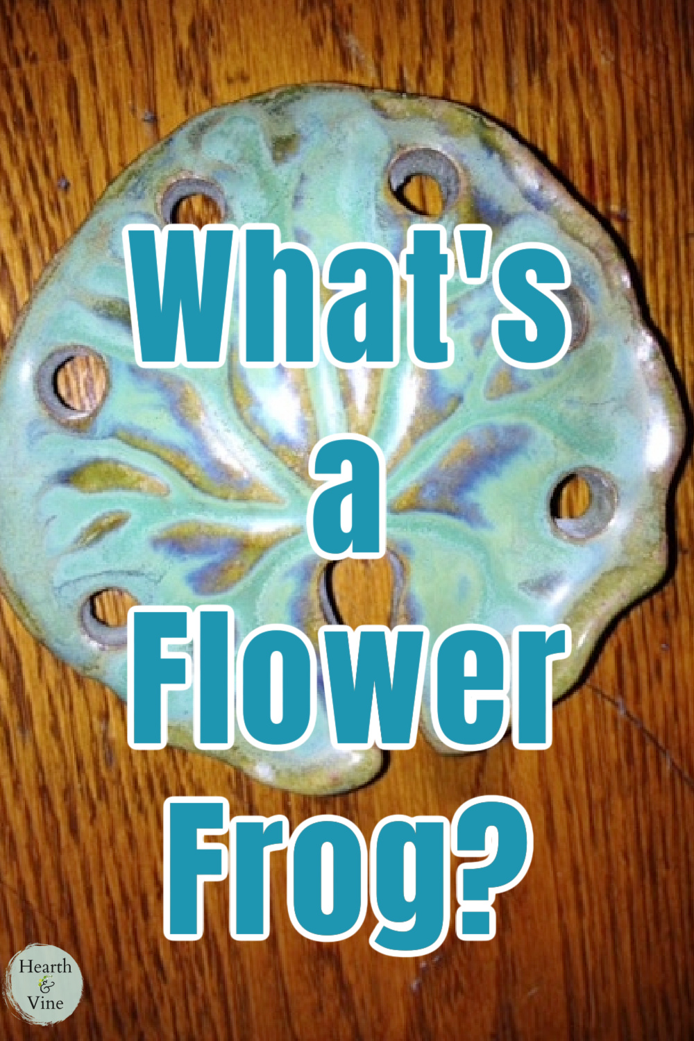 An aqua colored antique flower frog.