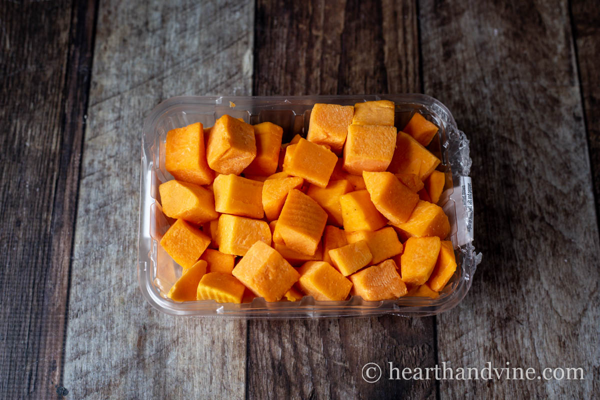 A container of chopped peeled butternut squash.