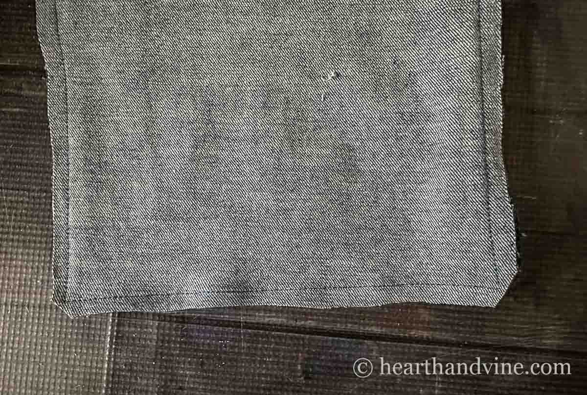 The bottom of two pieces of denim fabric sewn together and the corners clipped.