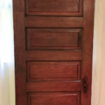 An antique paneled wood door.
