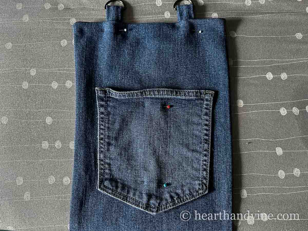 Tabs and a pocket pinned to the jean backing.