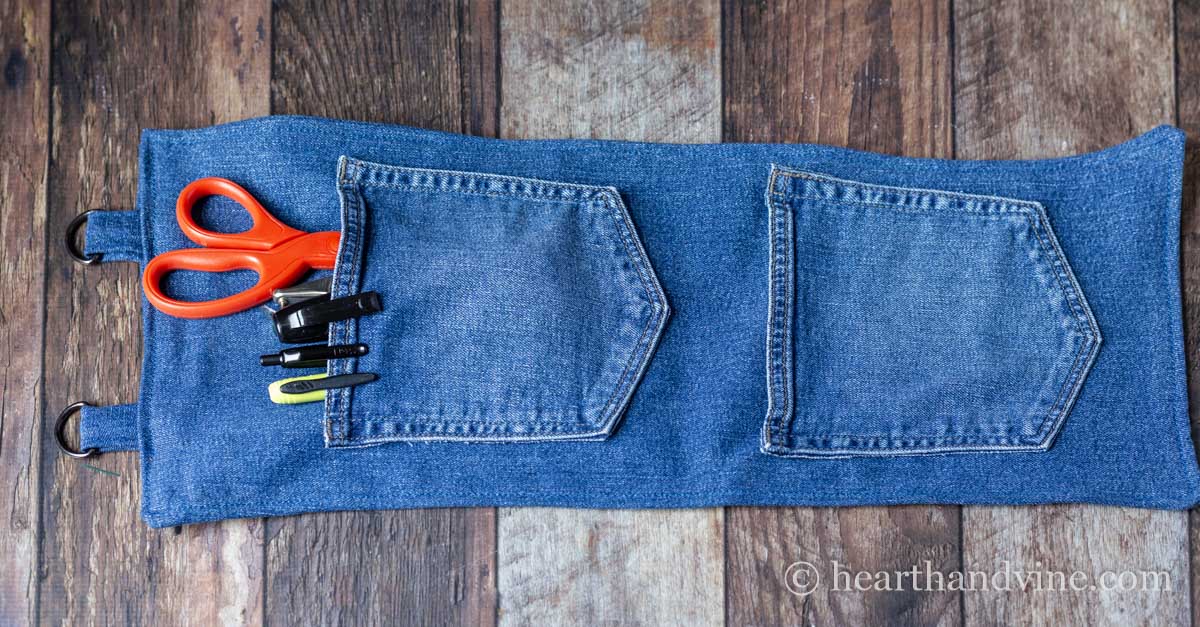 DIY hanging pocket organizer laid flat on a table.