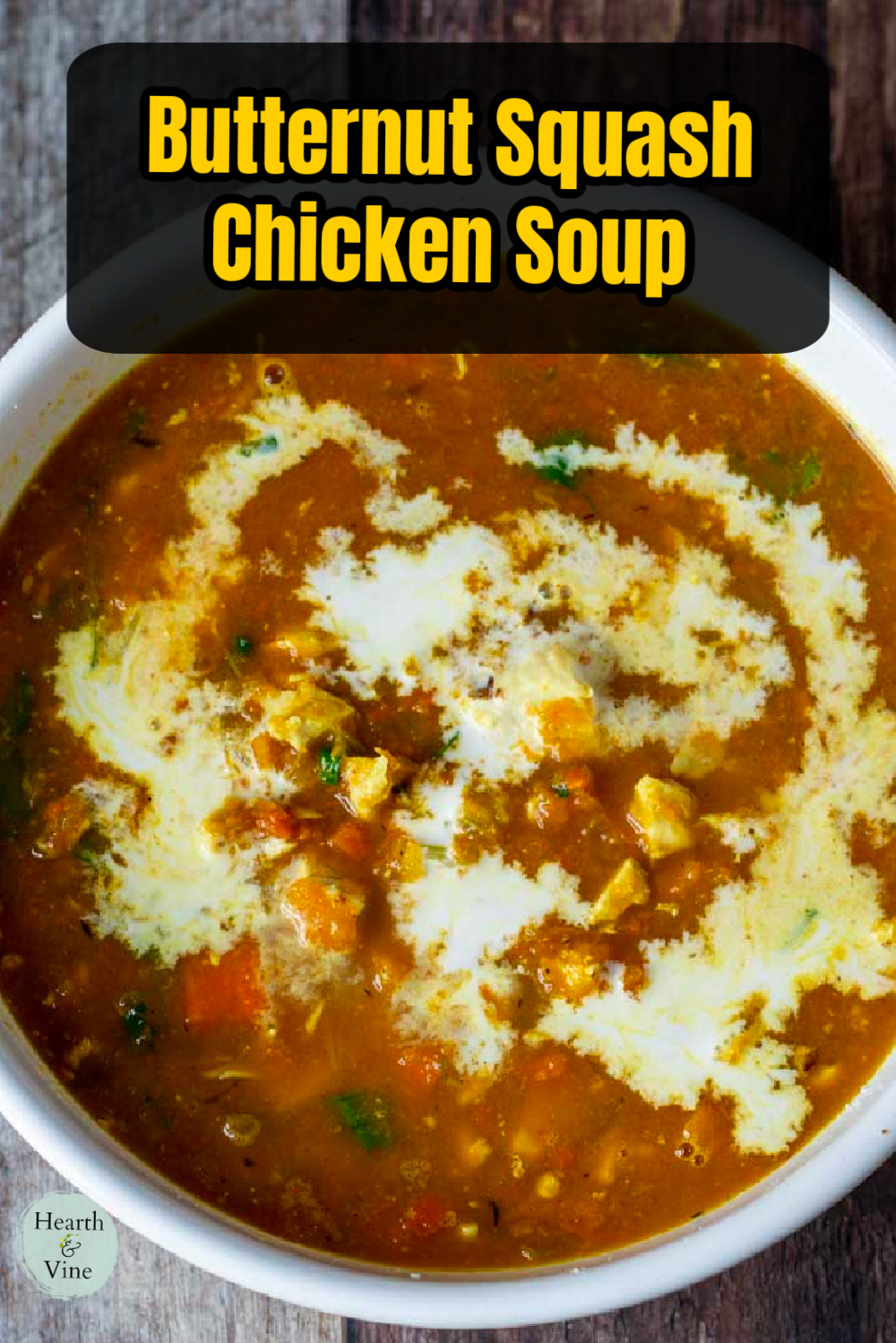 Bowl of butternut squash and chicken soup with a splash of cream on top.