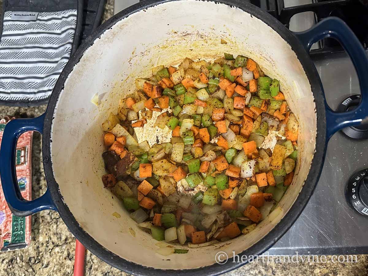 Chopped carrots, onion and celery in a large pot with spices and olive oil.