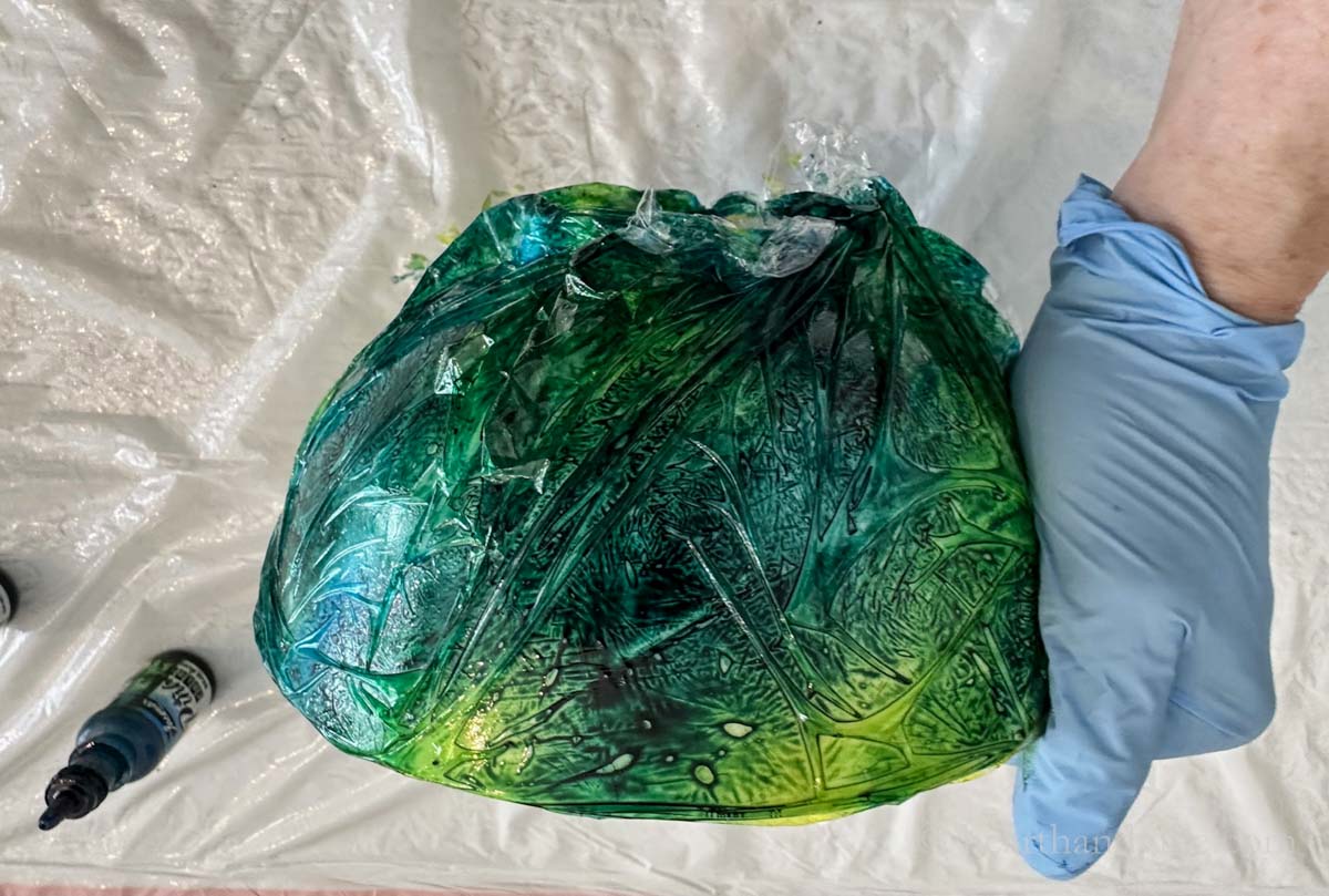 Ceramic bowl covered with inks and plastic wrap.
