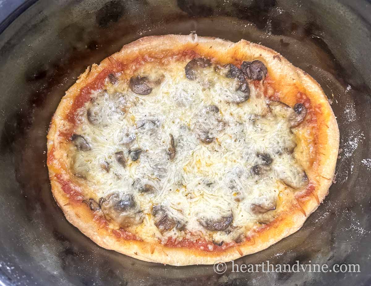 Pizza in a slow cooker almost done cooking.