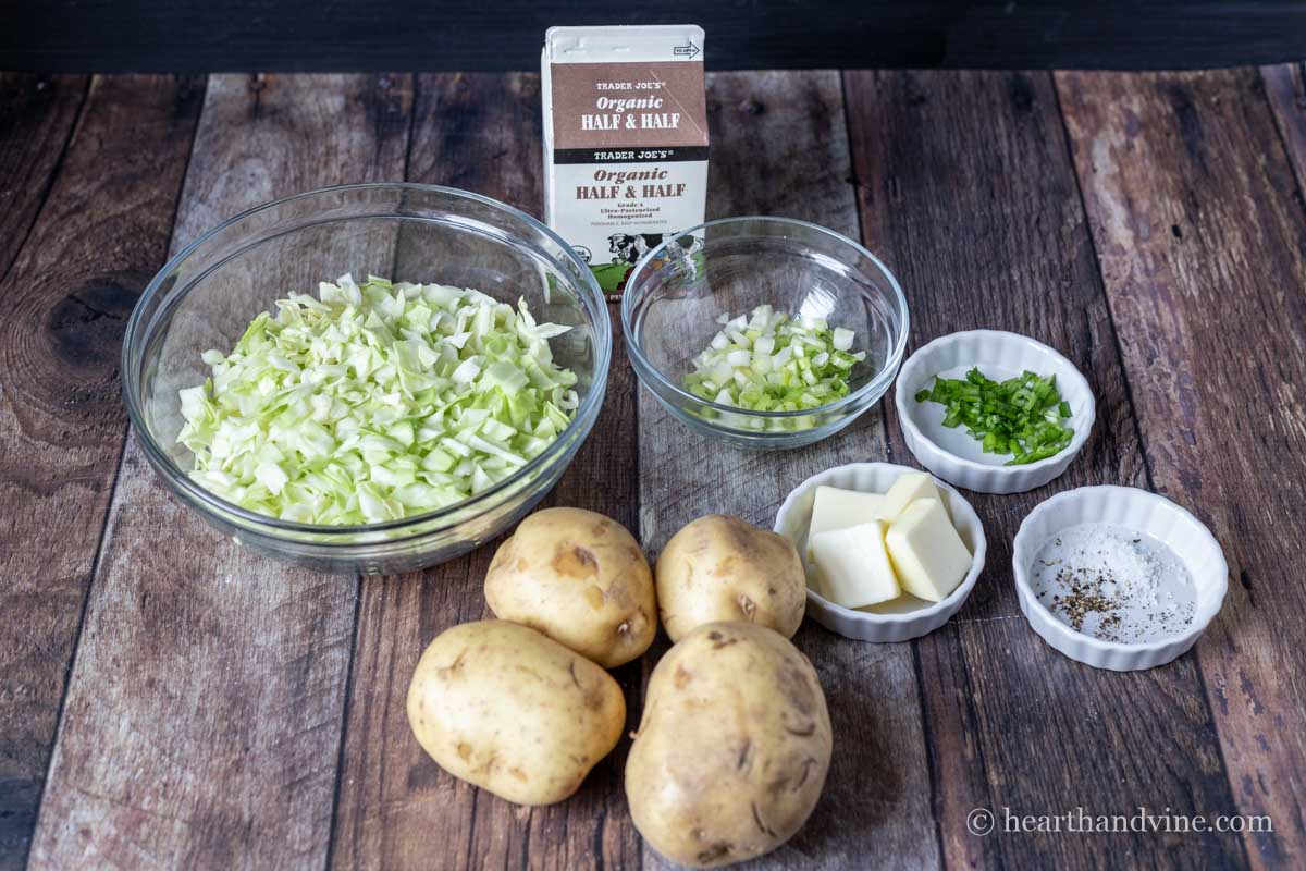 Ingredients for Irish Colcannon including potatoes, green cabbage, scallions, butter, salt & pepper.