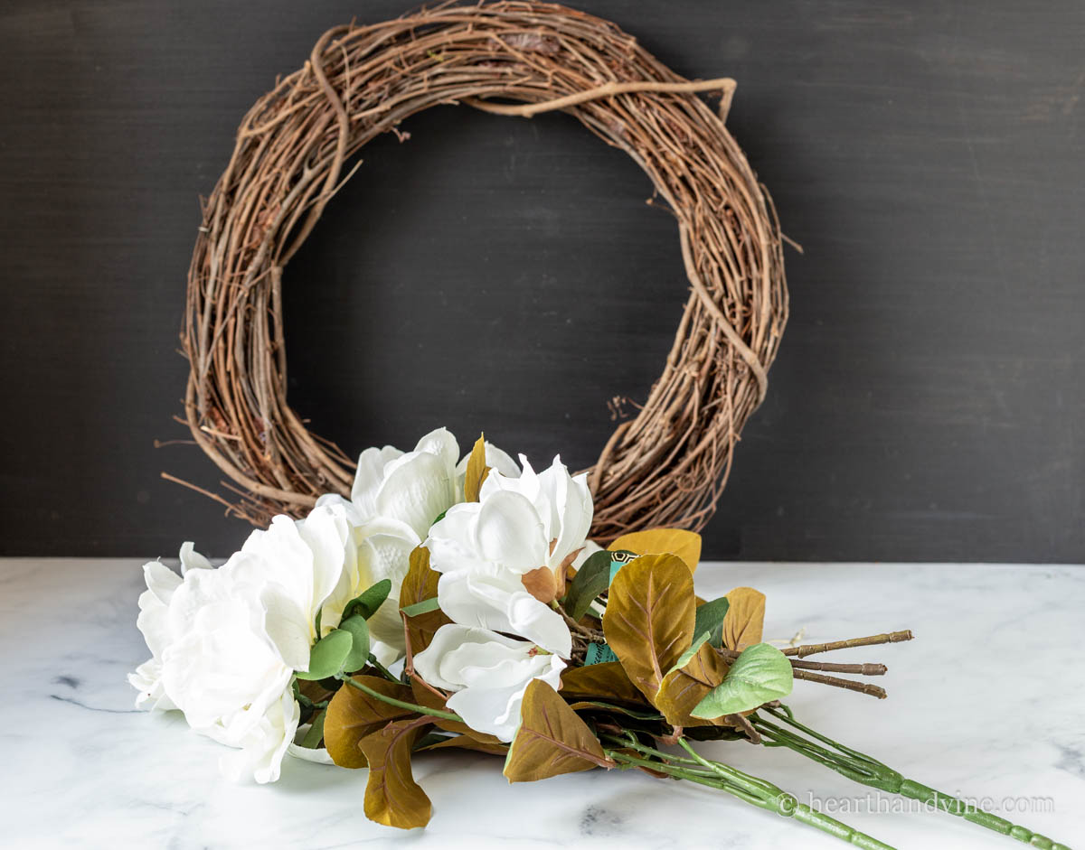 Grapevine wreath and artificial magnolia flowers.