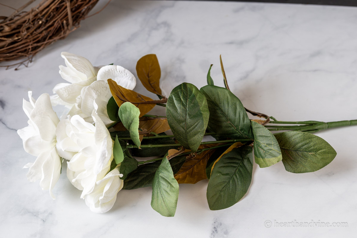 A bush of faux magnolia flowers.