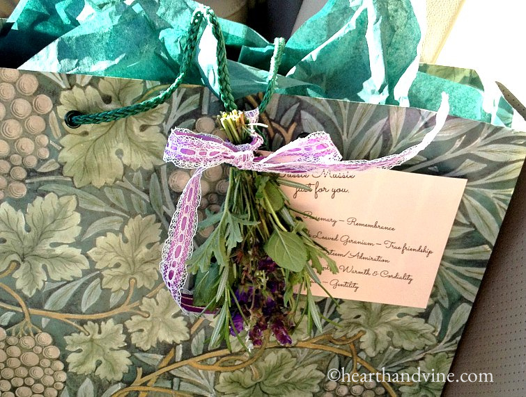 A tussie mussie tied to a bag with a card with the meanings of each flower.