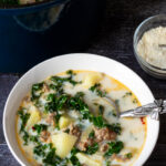 A serving bowl of zuppa toscana soup.