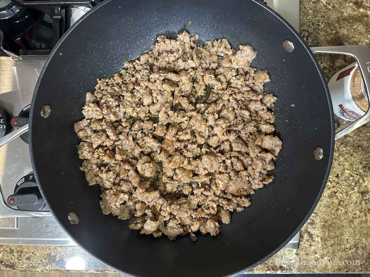 Italian sausage in a large skillet.