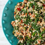 Partial view of a large greens and grains bowl.