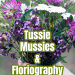 A hand holding a bouquet of flowers like a tussie mussie.