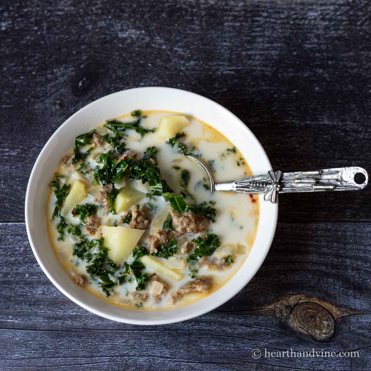 Bowl of zuppa zosana soup with an ornate spoon.
