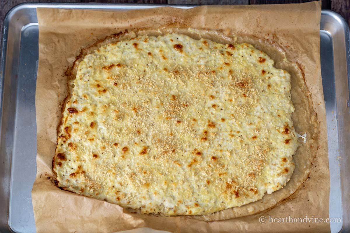 Chicken parm pizza crust after baking in the oven.