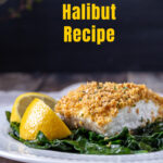 Baked halibut on a plate of spinach with lemon wedges.