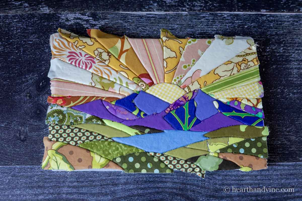 The foam board filled with fabric punched into the design.