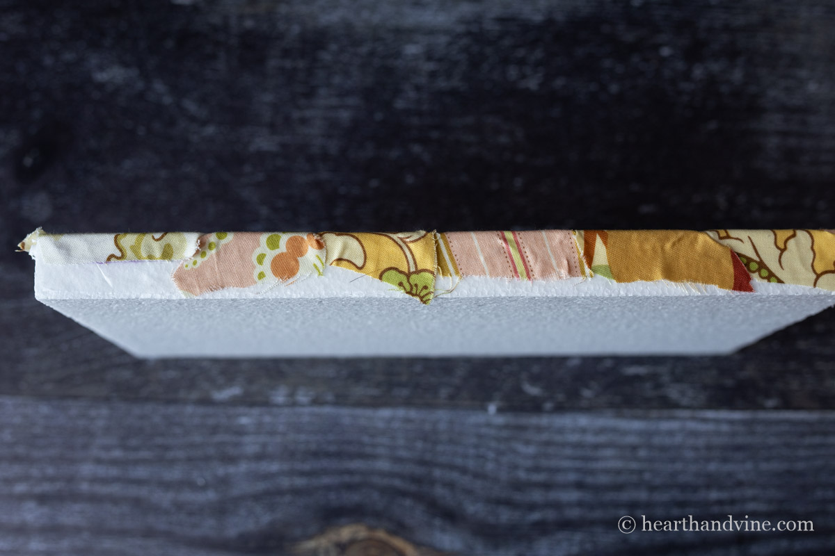 The edge of the Kinusaiga art pressed onto more adhesive for finishing.