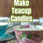 A floral teacup candle with others in the background.